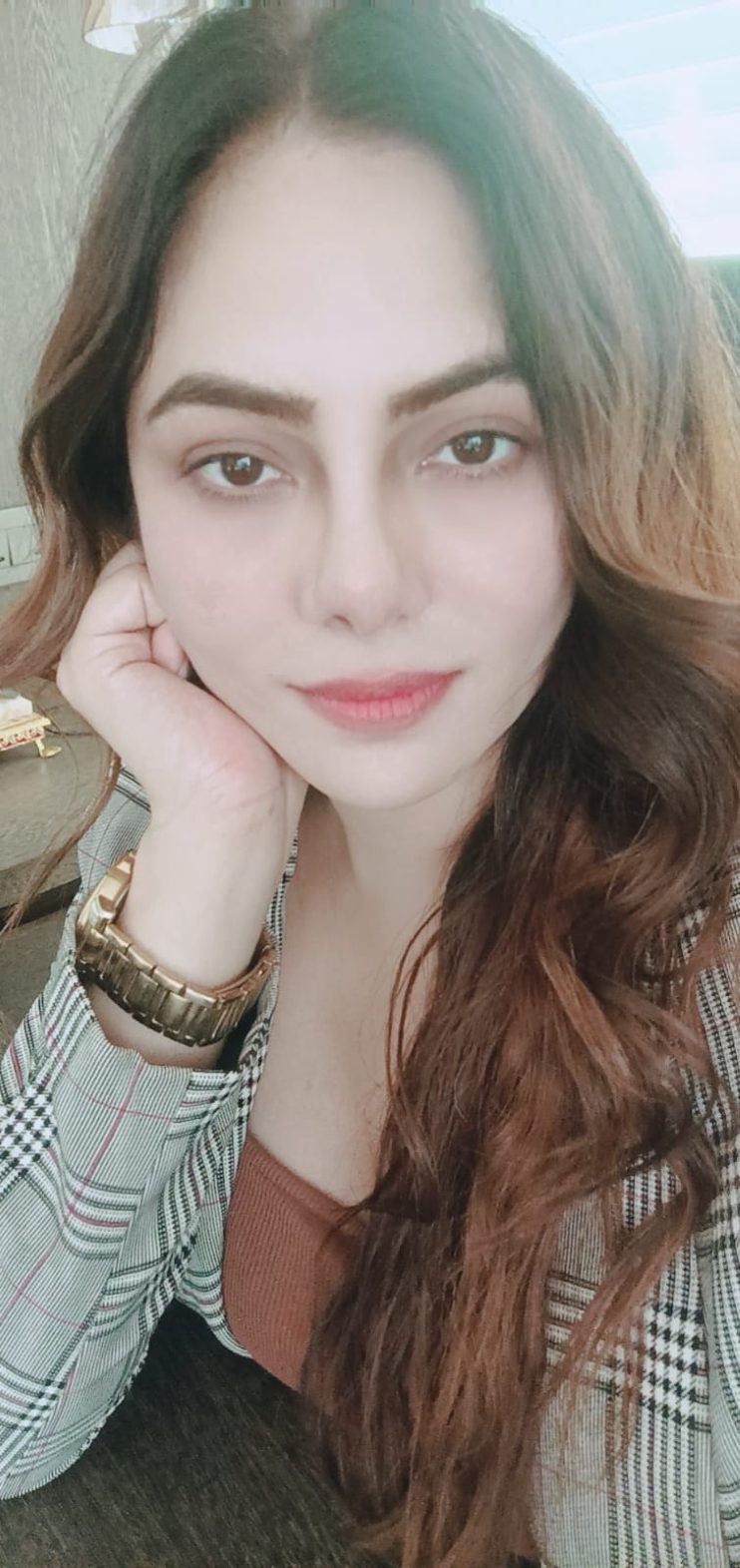 Vibha Jain resting her chin on her hand in a relaxed, attentive pose.
